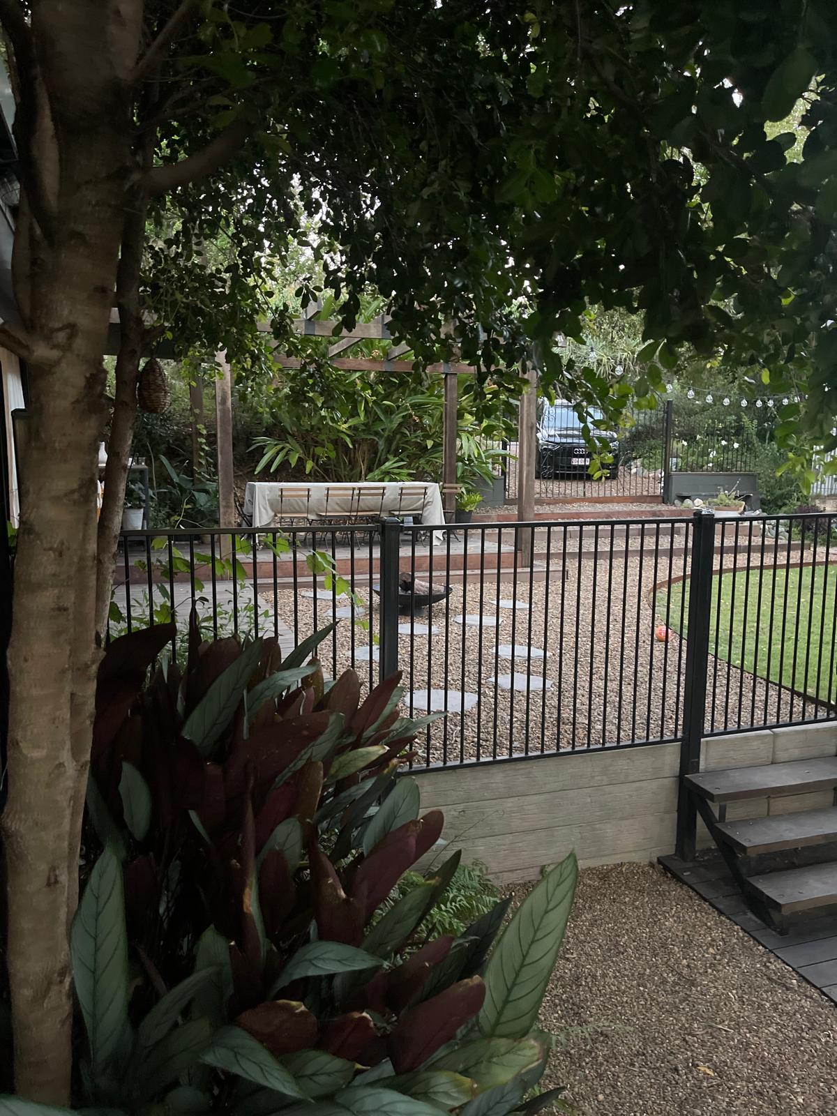 Finished structural landscaping and fenced gravel yard by Scapem8